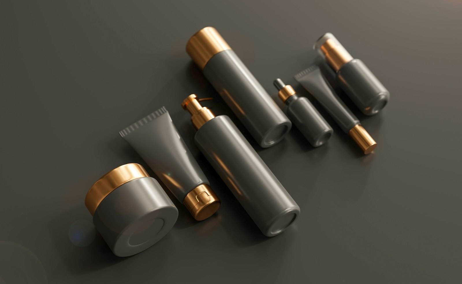 Unbranded grey and gold beauty tubes and jars laid out on a table